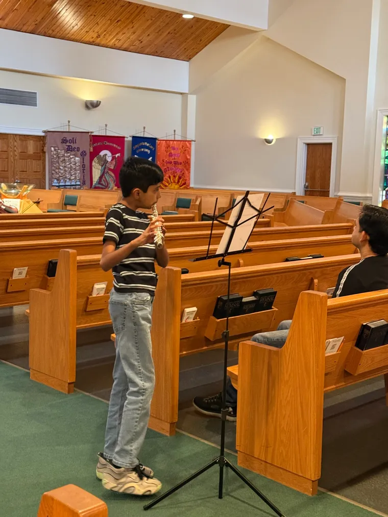 A young student trying the flute at Instrument Discovery Day